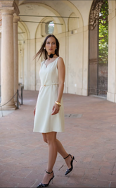 a lady in a white mini vest dress